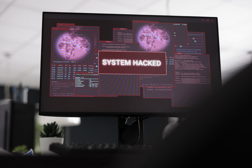 Computers displaying hacked system alert message showing on screen